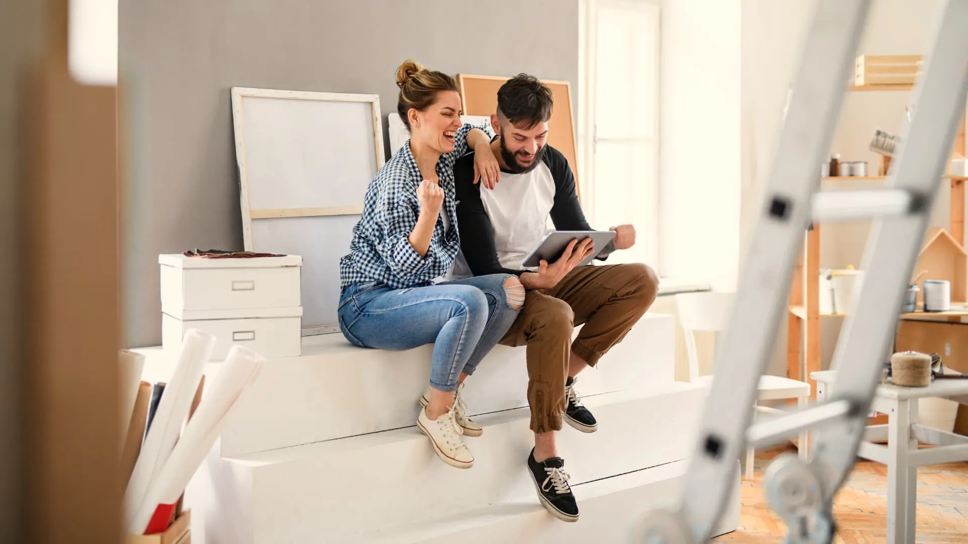 Homeowners looking at a tablet while planning their interior project